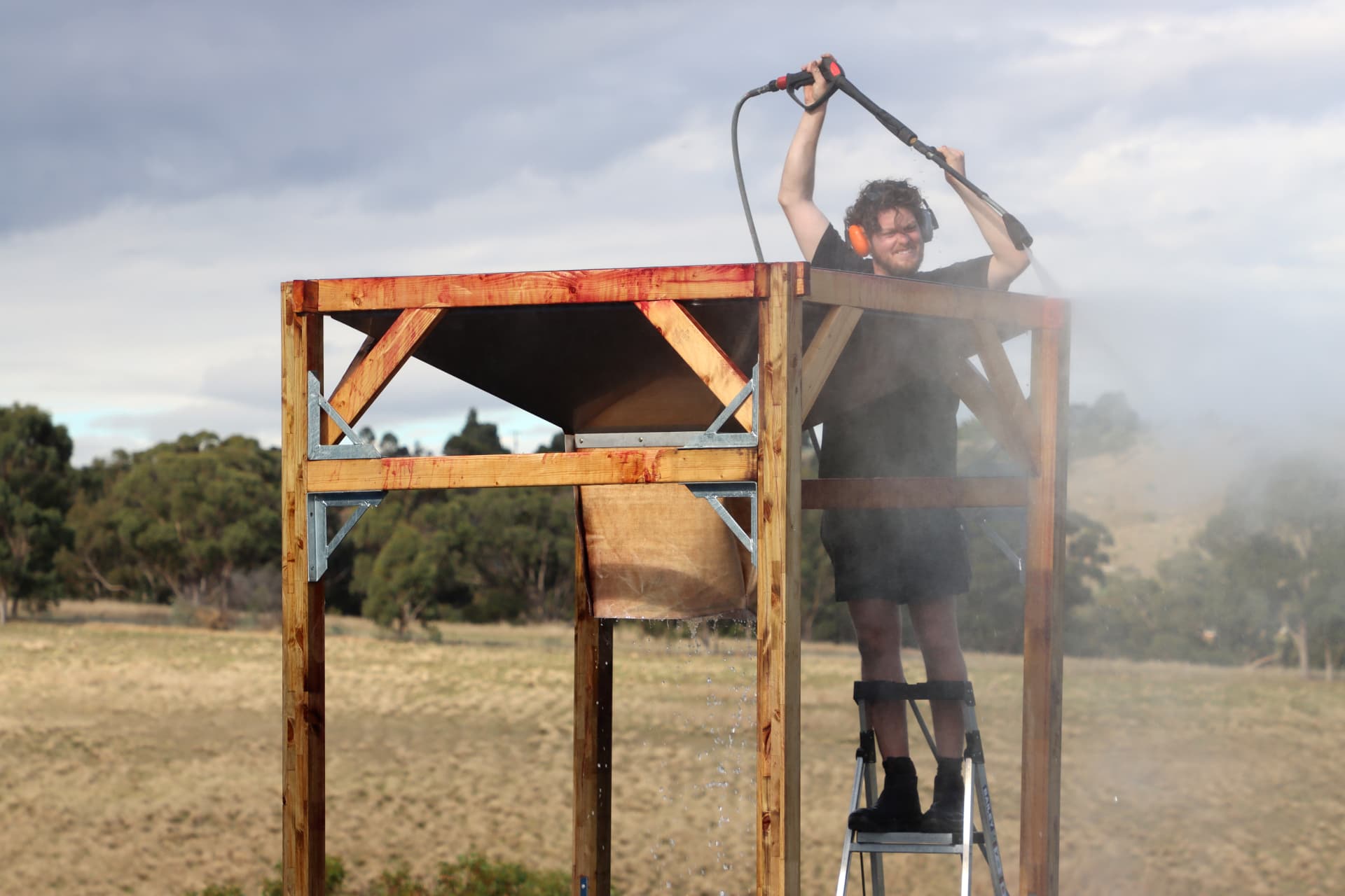 Alex cleaning winery equipment outdoors